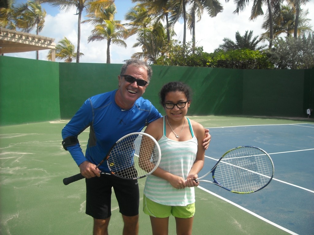 tennis instructor posing with student