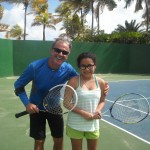 tennis instructor posing with student