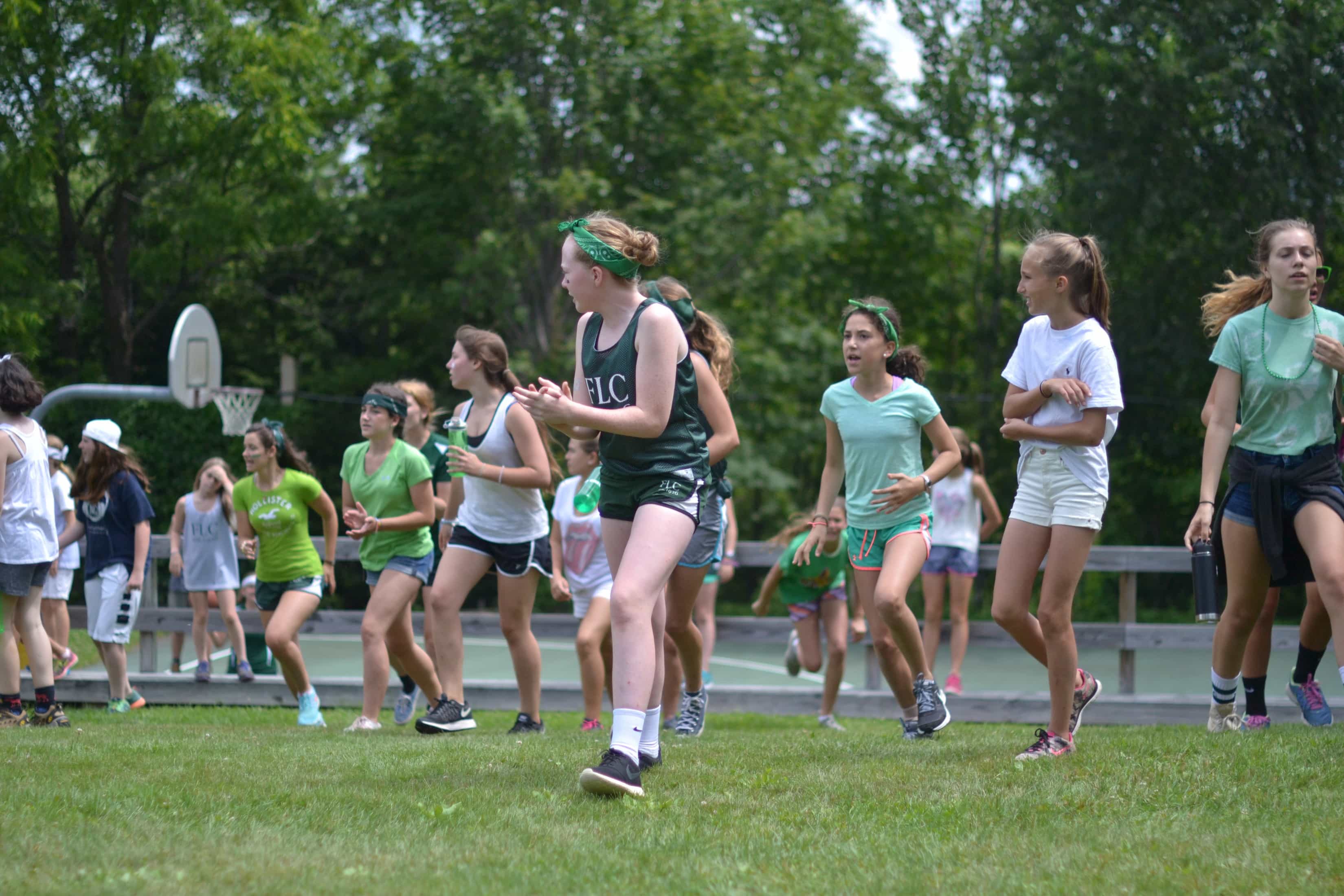 girls running in relay race