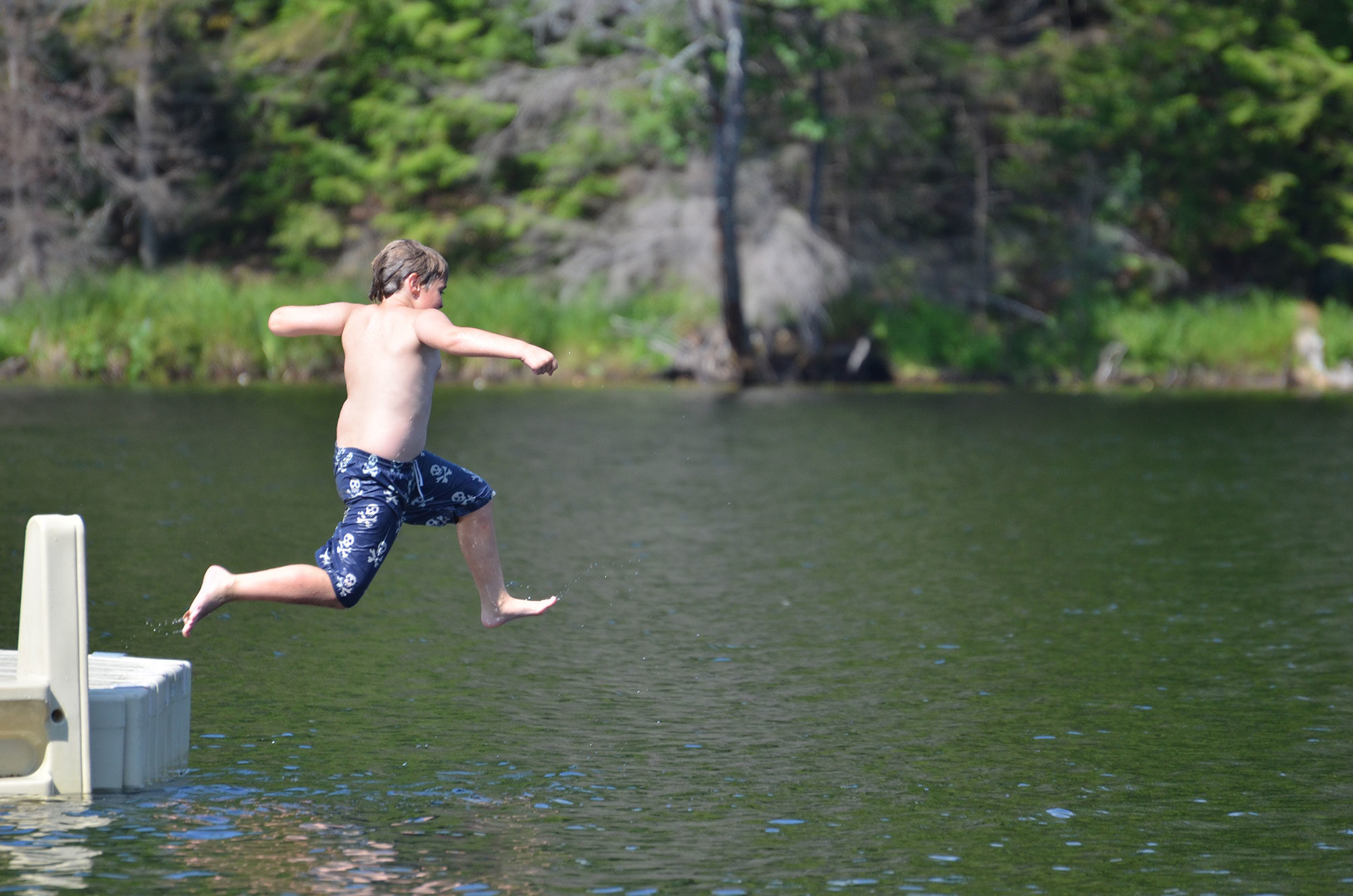 kid jumping into water