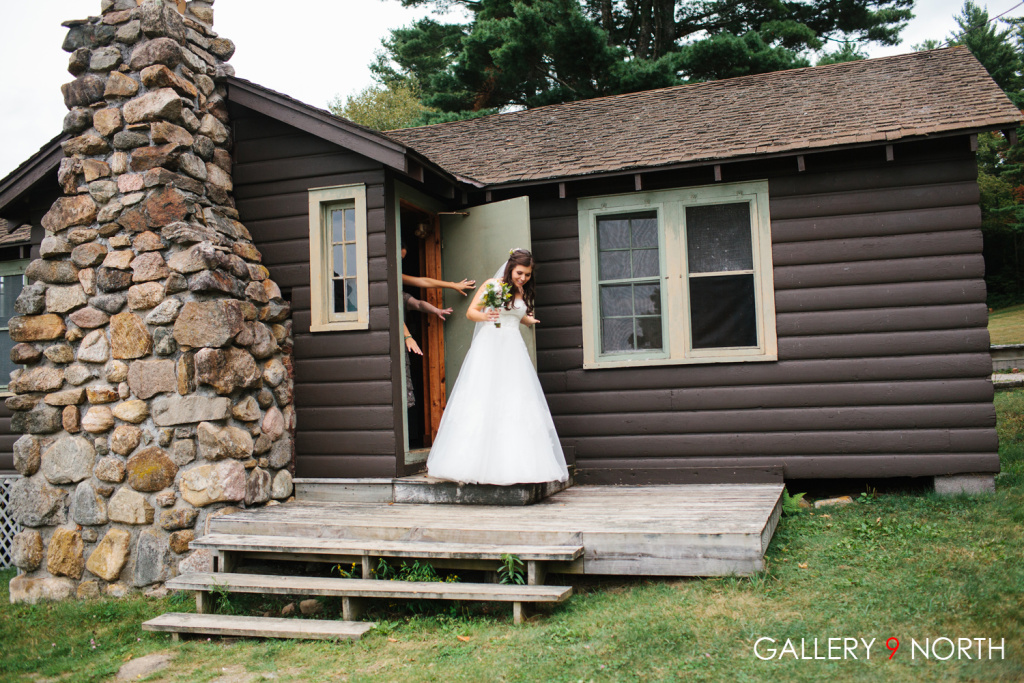 bride in front of cabin